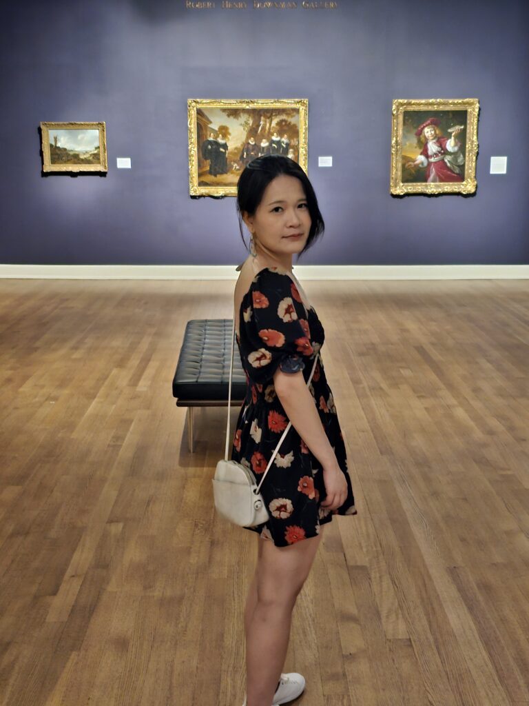 Ying in a museum in New Orleans looking back.